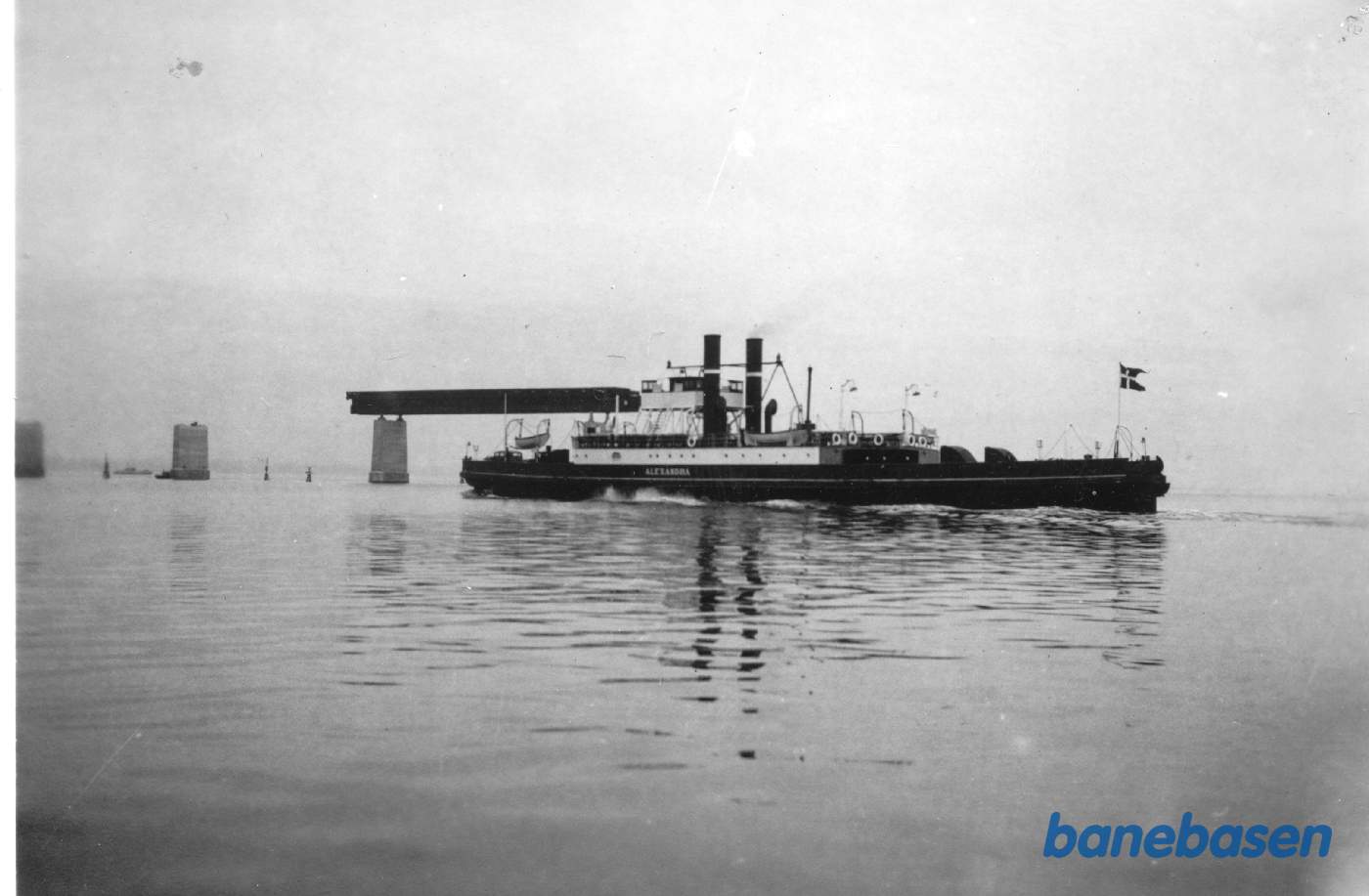 Hjulfærgen krydser Storstrømmen, i baggrunden er broen under anlæg