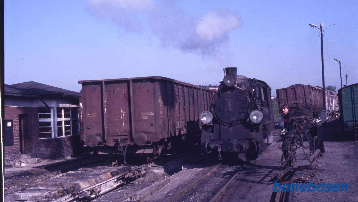 Smalsporsdamplokomotiv (750 mm) rangerer med overførte normalsporsgodsvogne