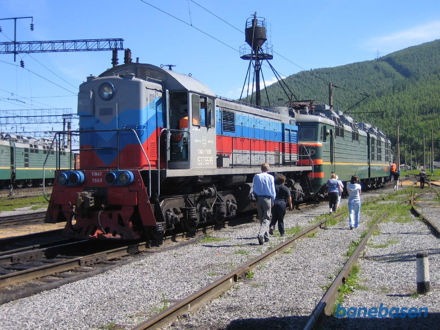 Turister på jernbaneområdet på vej ud til 2 damplokomotiver