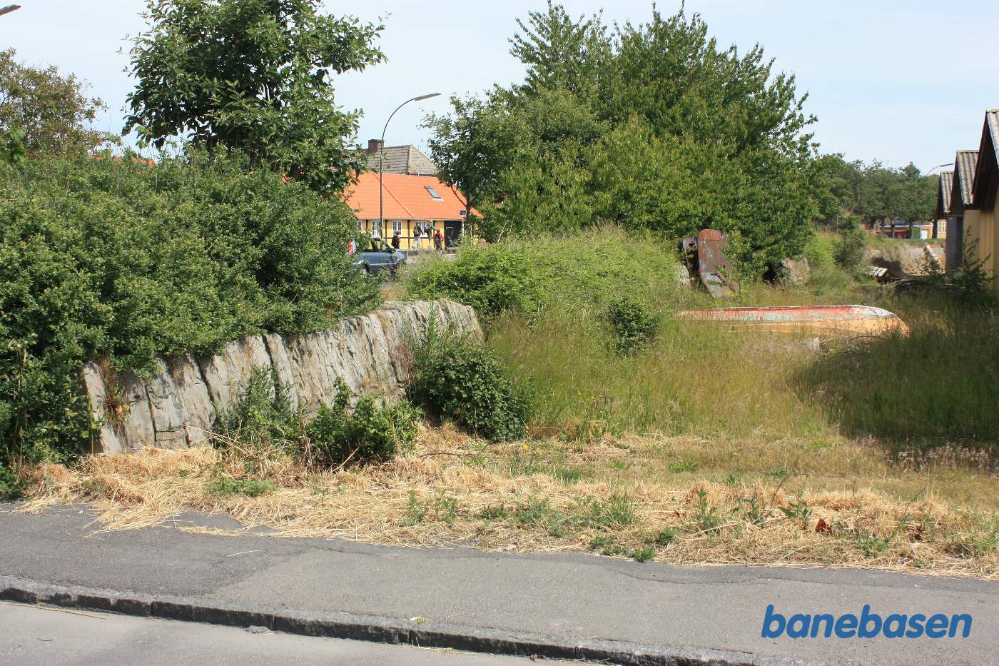 Stensætningen skærmede banen mod havet til højre. Banen løb i en stor bue på den anden side af stensætningen. Vi ser i retning af Nexø station Stensætningen skærmede banen mod havet til højre. Banen løb i en stor bue på den anden side af stensætningen. Vi ser i retning af Nexø station