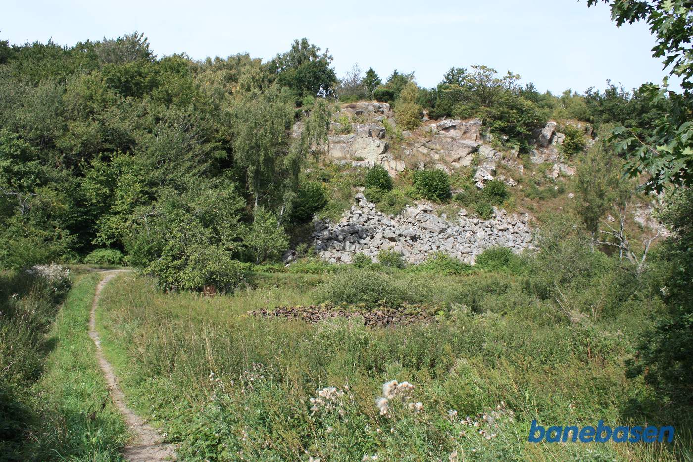 Vi er på en side sti og kigger på banestien langs klippeformationen, Rønne til venstre og Sandvig til højre Vi er på en side sti og kigger på banestien langs klippeformationen, Rønne til venstre og Sandvig til højre