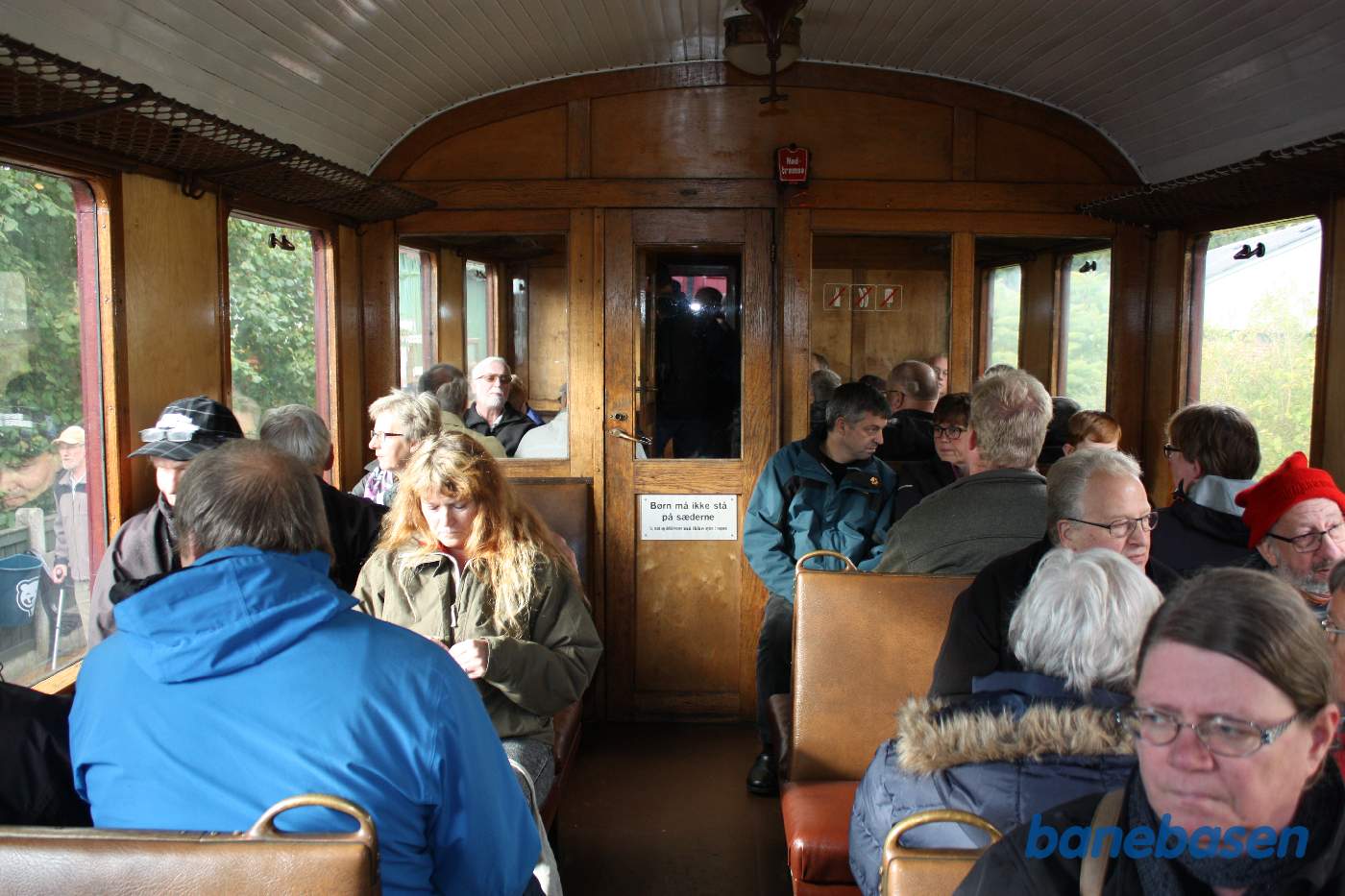 Rejsende i en Triangelmotorvogn venter på at toget skal køre