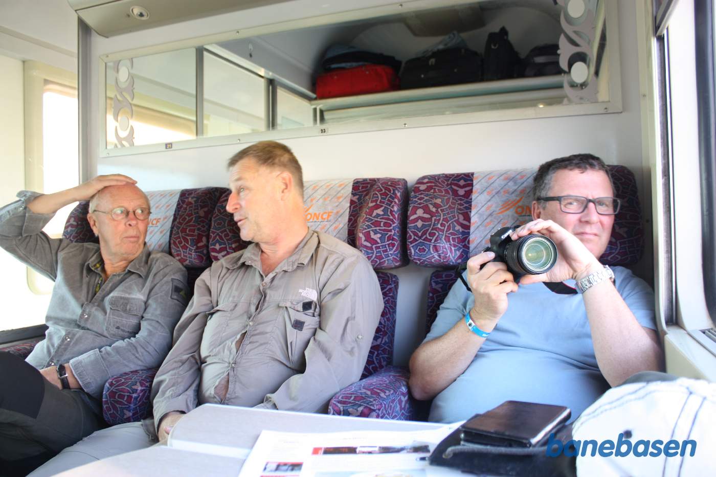 Tre turister sidder i toget på 1.klasse og nyder turen fra Marrakech til Casablanca