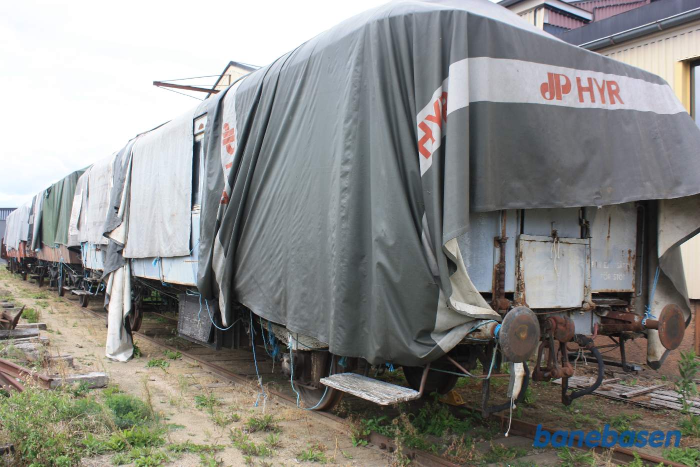 Udenfor museet står flere vogne pakket ind i presenninger