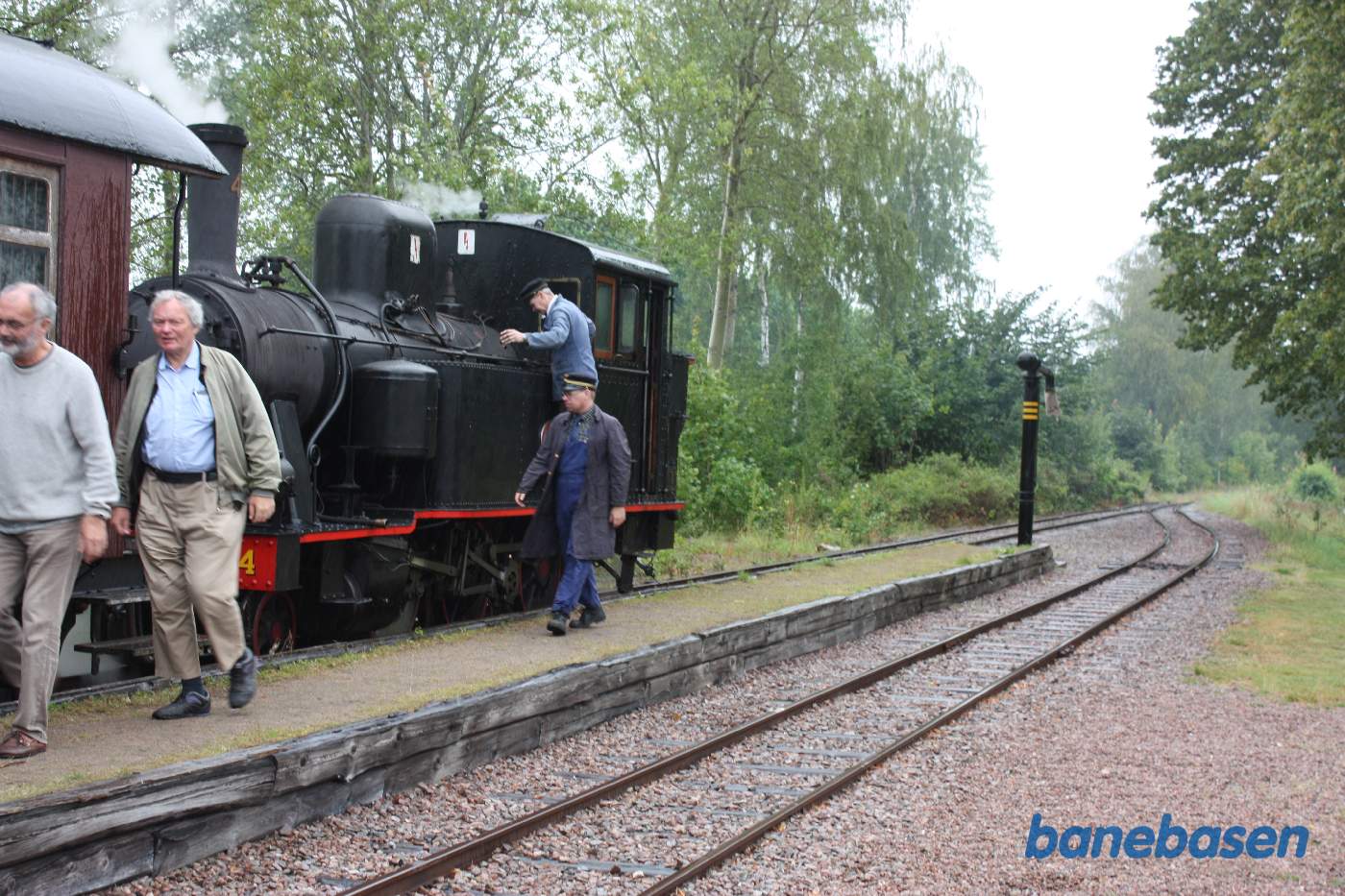På stationen stiger gæsterne ud i regnvejret
