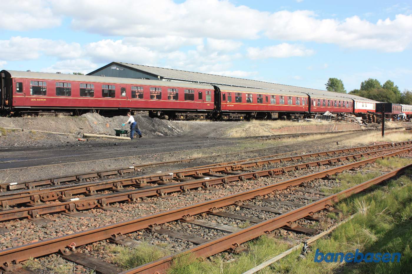En række personvogne med den store vognhal bagved