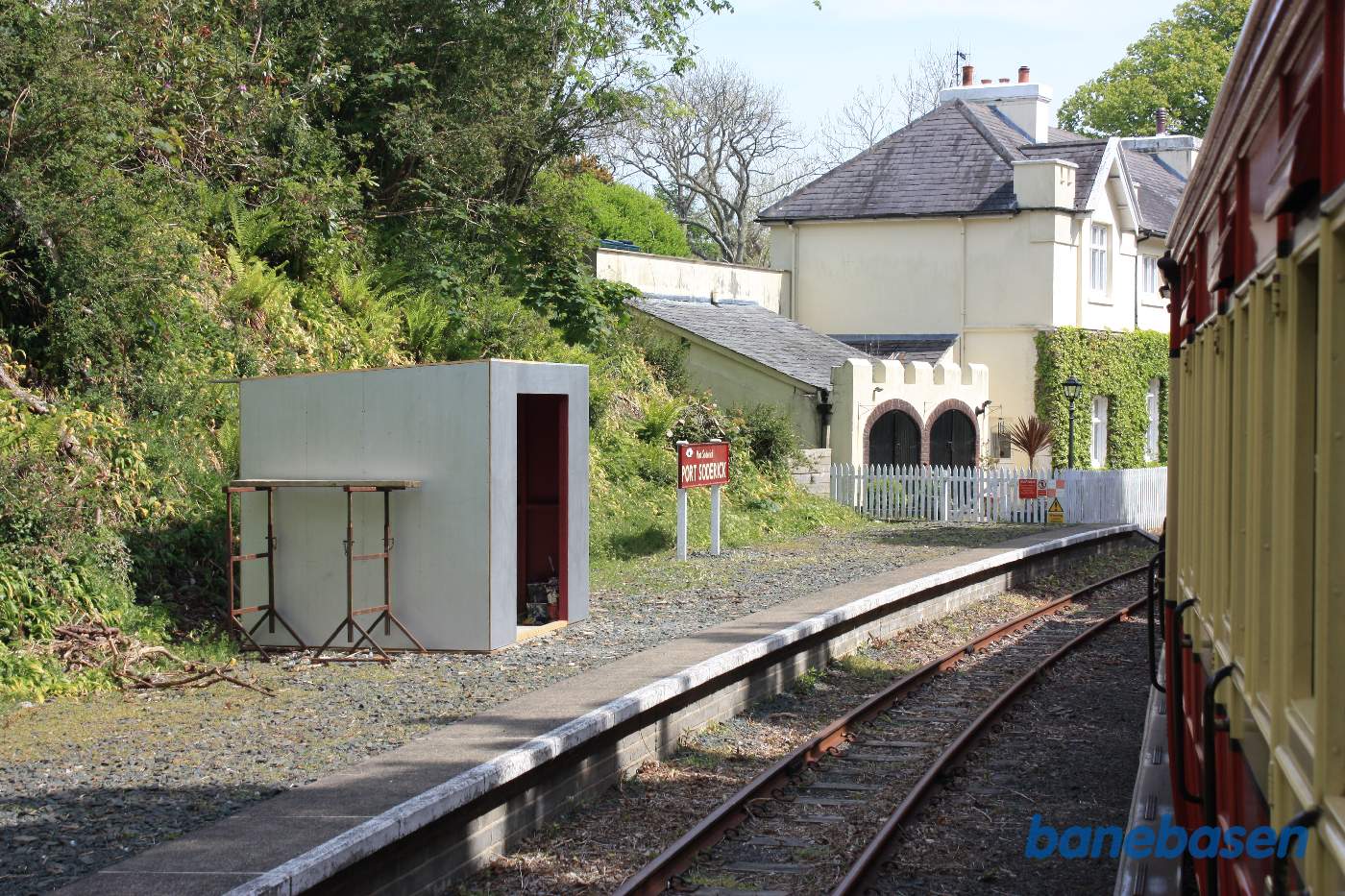 Stationsbygningen set fra perronen og fra toget