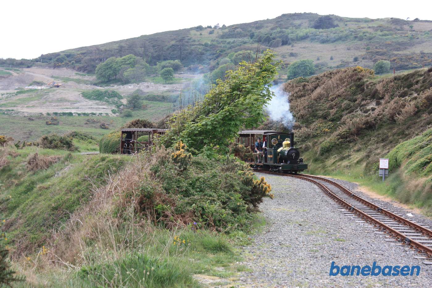 Damptog på vej langs bjergkanten ned mod havet
