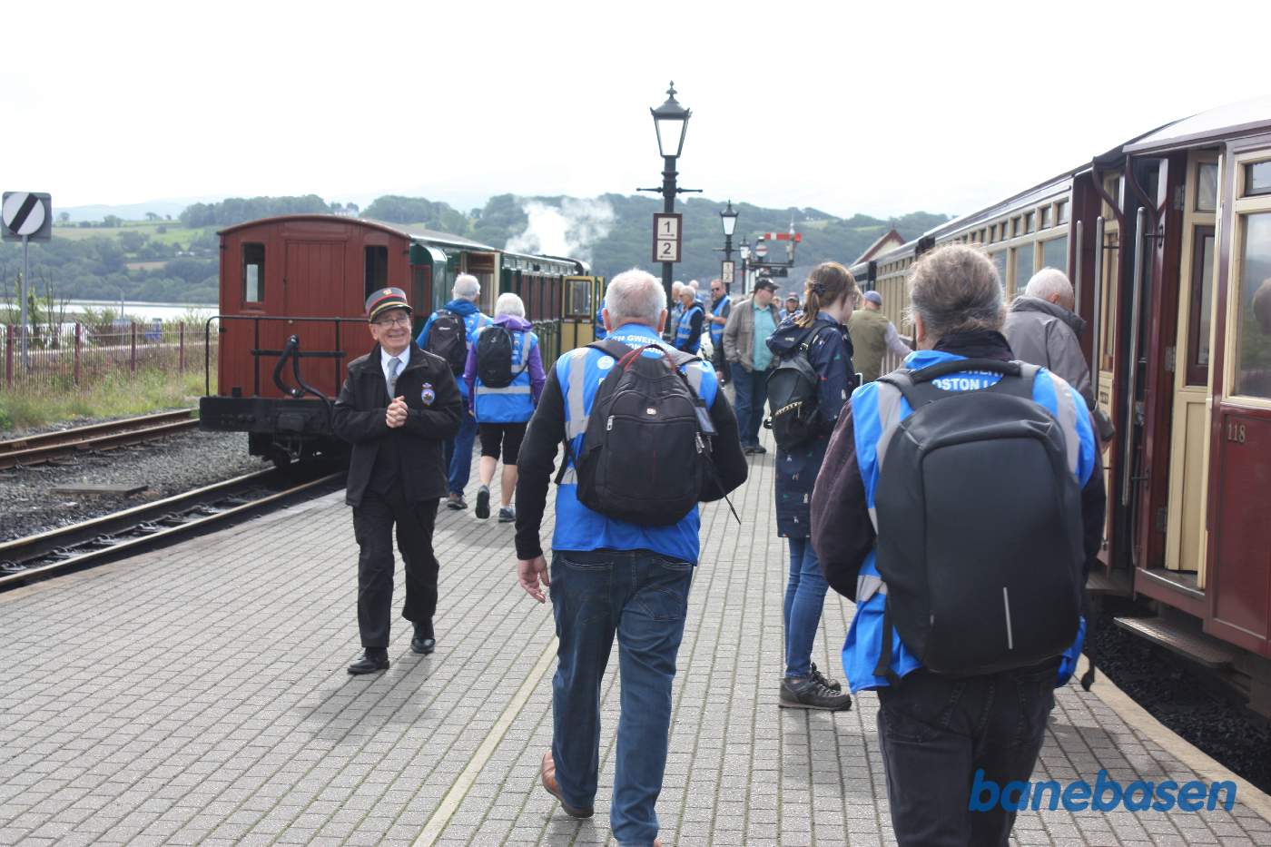 Damptoget ankommet og passagererne stiger ud. Stationsforstanderen med et stort smil