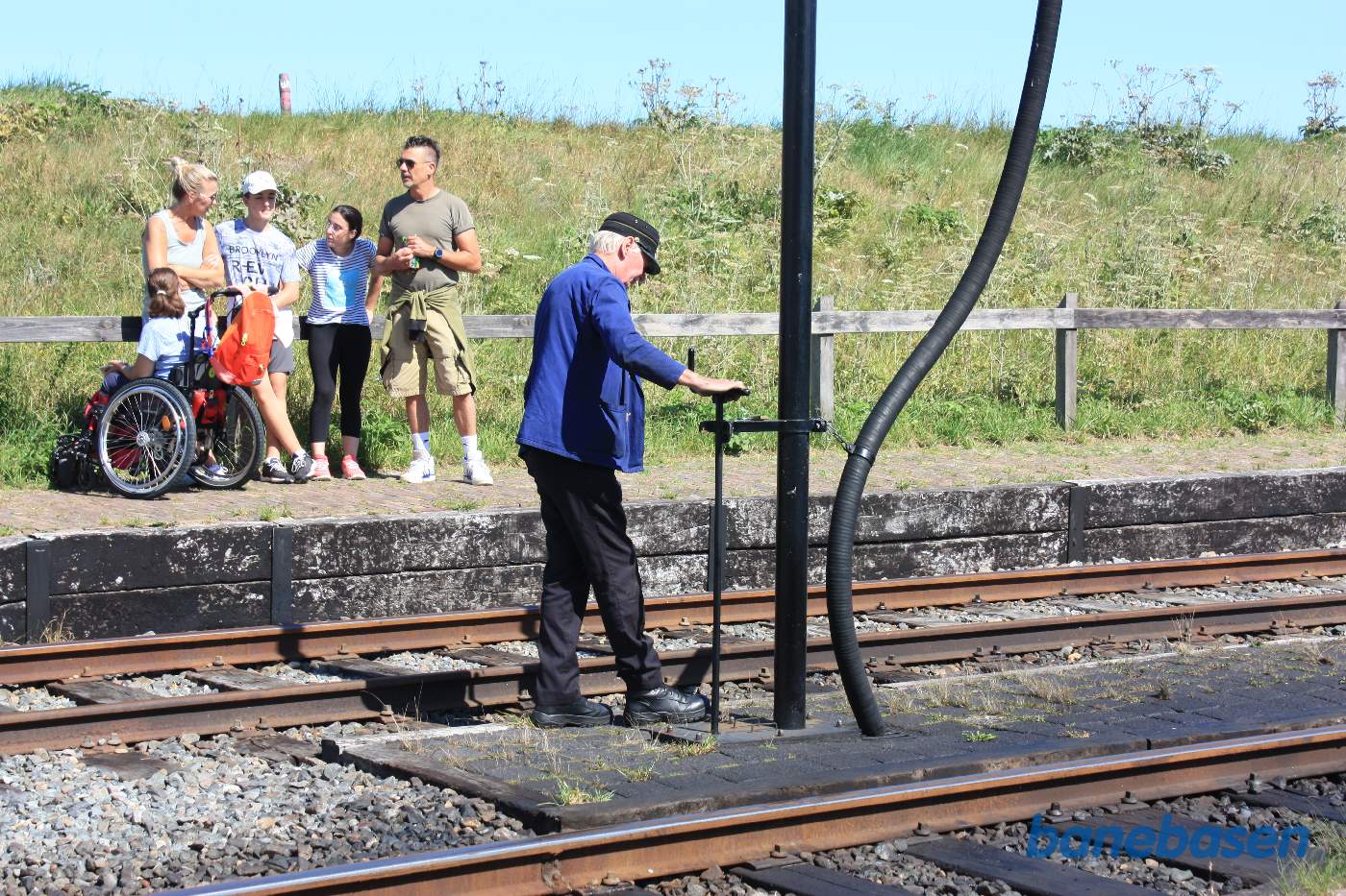 Fyrbøderen prøver at åbne for vandet for at skylle slam ud af slangen